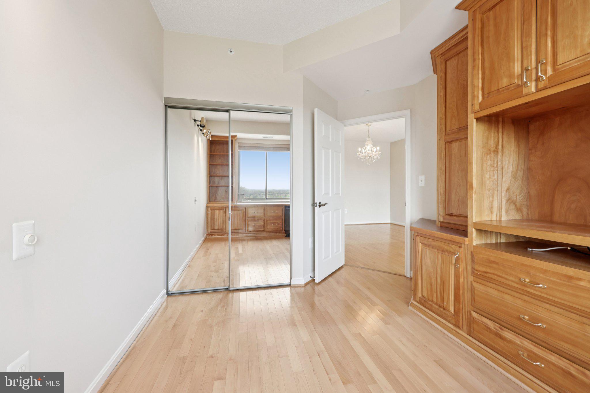 19375 Cypress Ridge Terrace, Unit 1111 Leesburg, VA 20176 - Photo 20 of 35 an empty room with wooden floor and windows