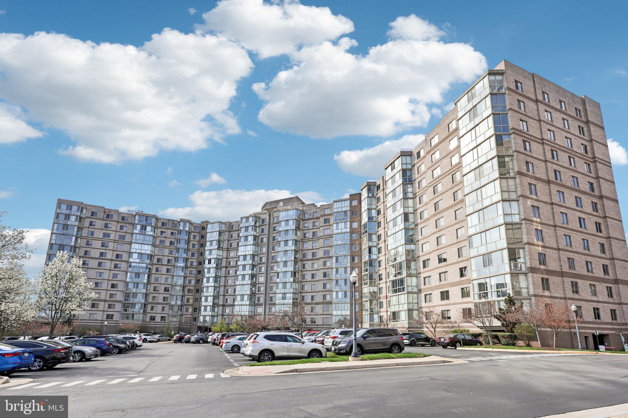 19375 Cypress Ridge Terrace, Unit 1111 Leesburg, VA 20176 - Photo 2 of 35 a city street lined with buildings and cars
