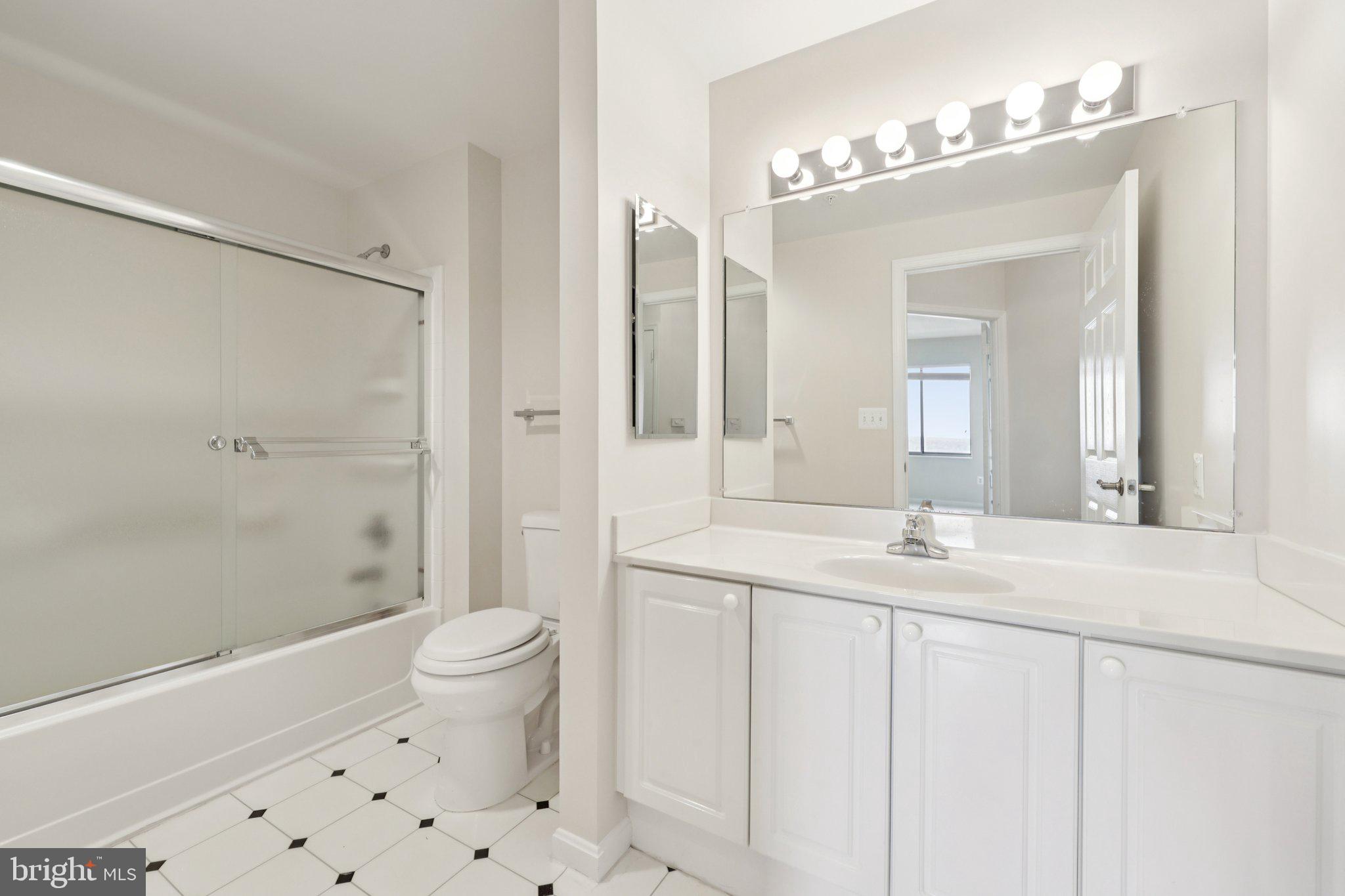 19375 Cypress Ridge Terrace, Unit 1111 Leesburg, VA 20176 - Photo 22 of 35 a bathroom with a sink a toilet and shower