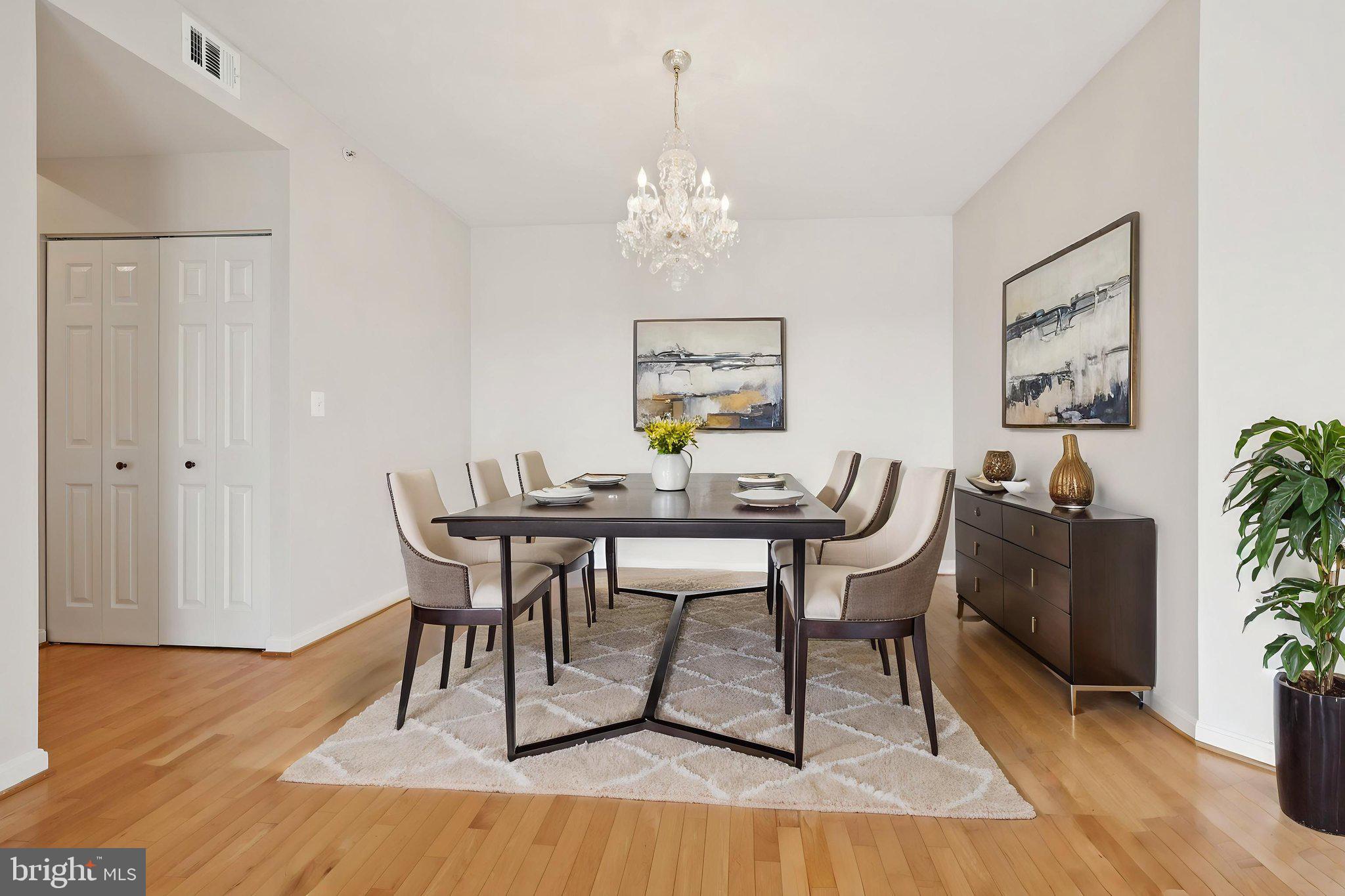 19375 Cypress Ridge Terrace, Unit 1111 Leesburg, VA 20176 - Photo 7 of 35 a view of a dining room with furniture and wooden floor