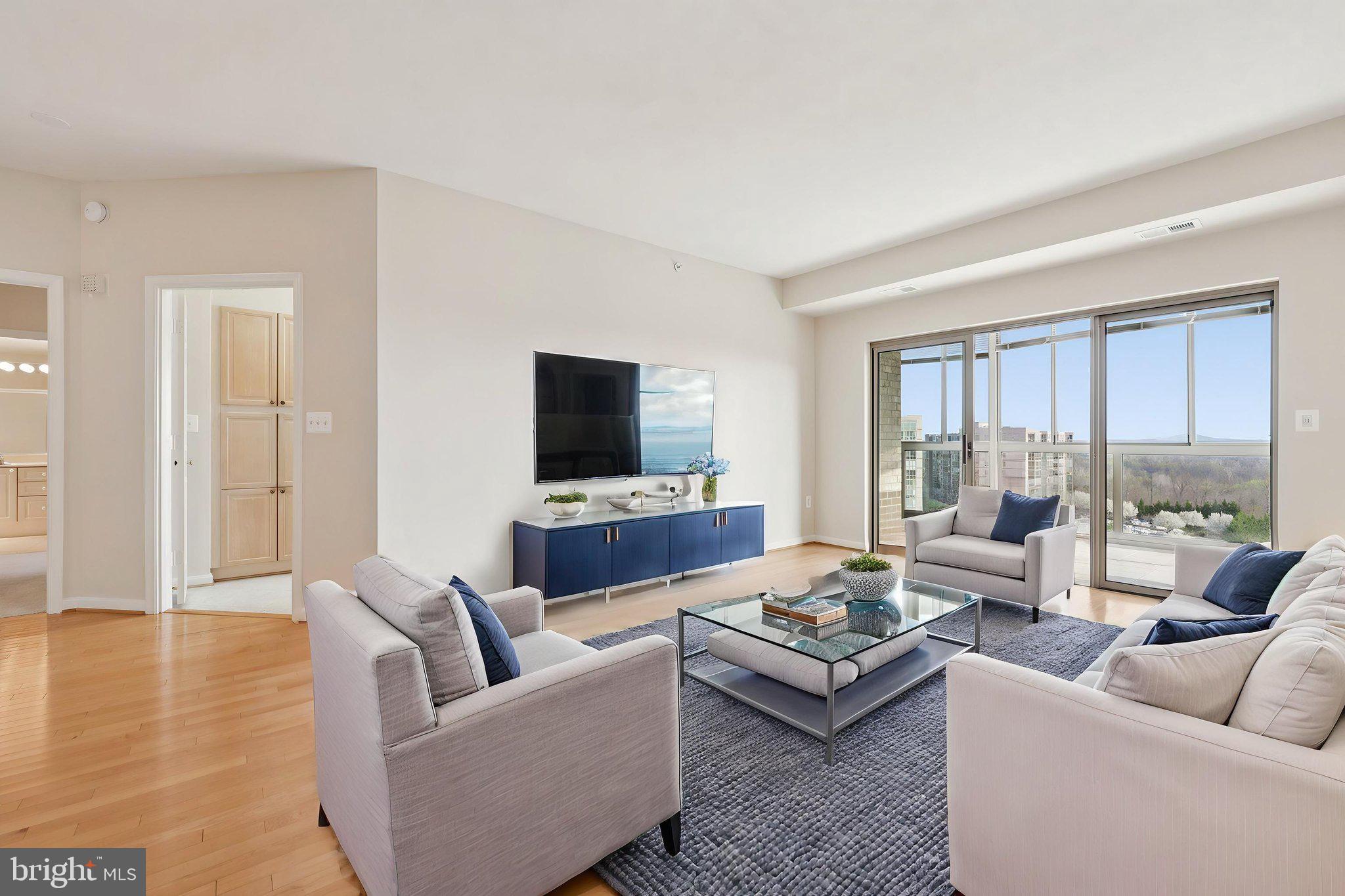 19375 Cypress Ridge Terrace, Unit 1111 Leesburg, VA 20176 - Photo 8 of 35 a living room with furniture and a flat screen tv
