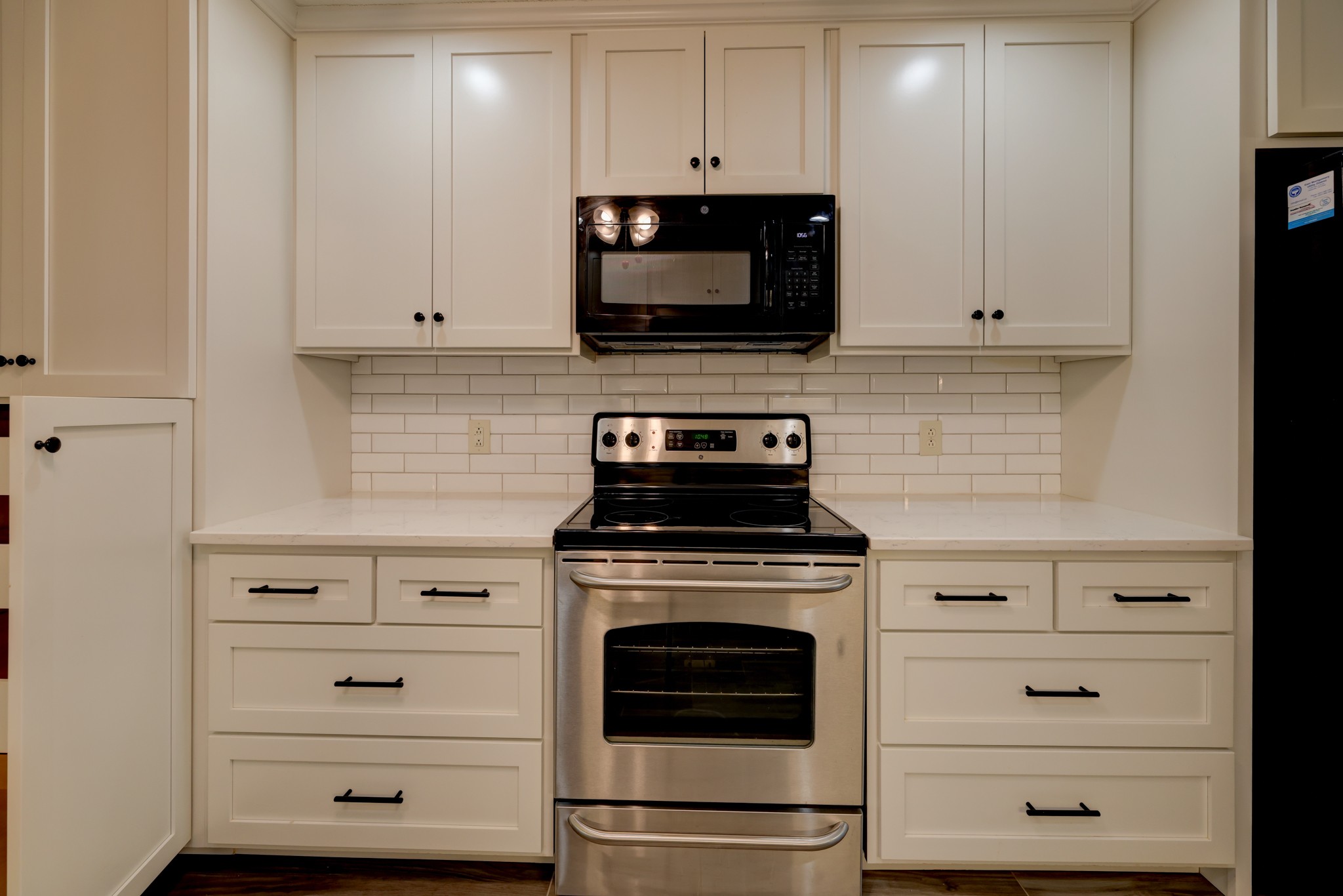 4445 Taylor Hall Lane Adams, TN 37010 - Photo 17 of 65 a kitchen with white cabinets and stainless steel appliances