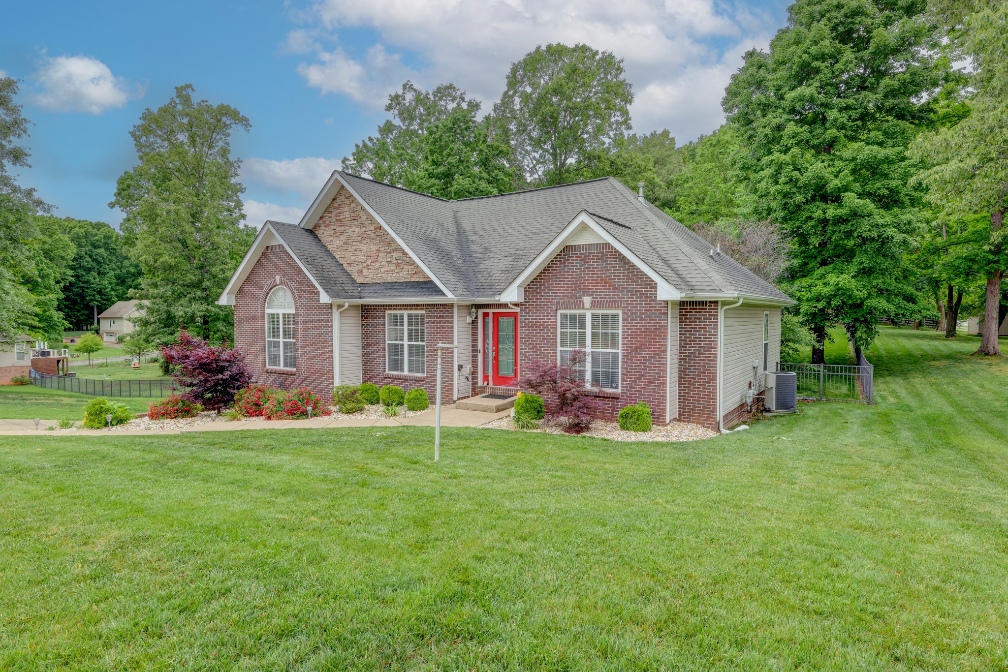4445 Taylor Hall Lane Adams, TN 37010 - Photo 2 of 65 a front view of a house with a yard and trees