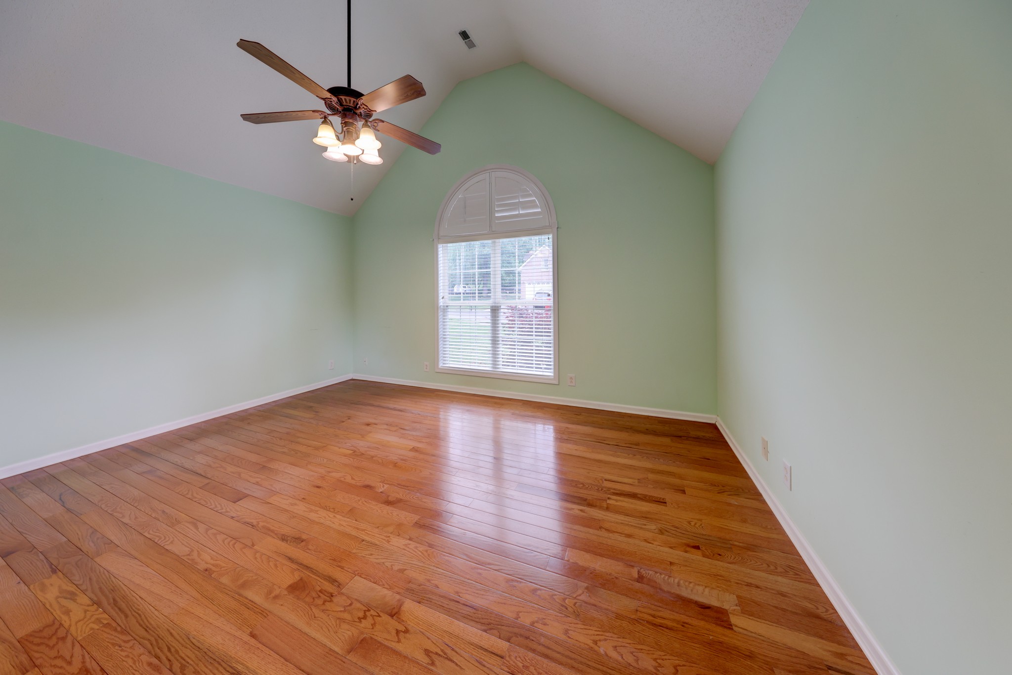 4445 Taylor Hall Lane Adams, TN 37010 - Photo 28 of 65 an empty room with wooden floor chandelier fan and windows