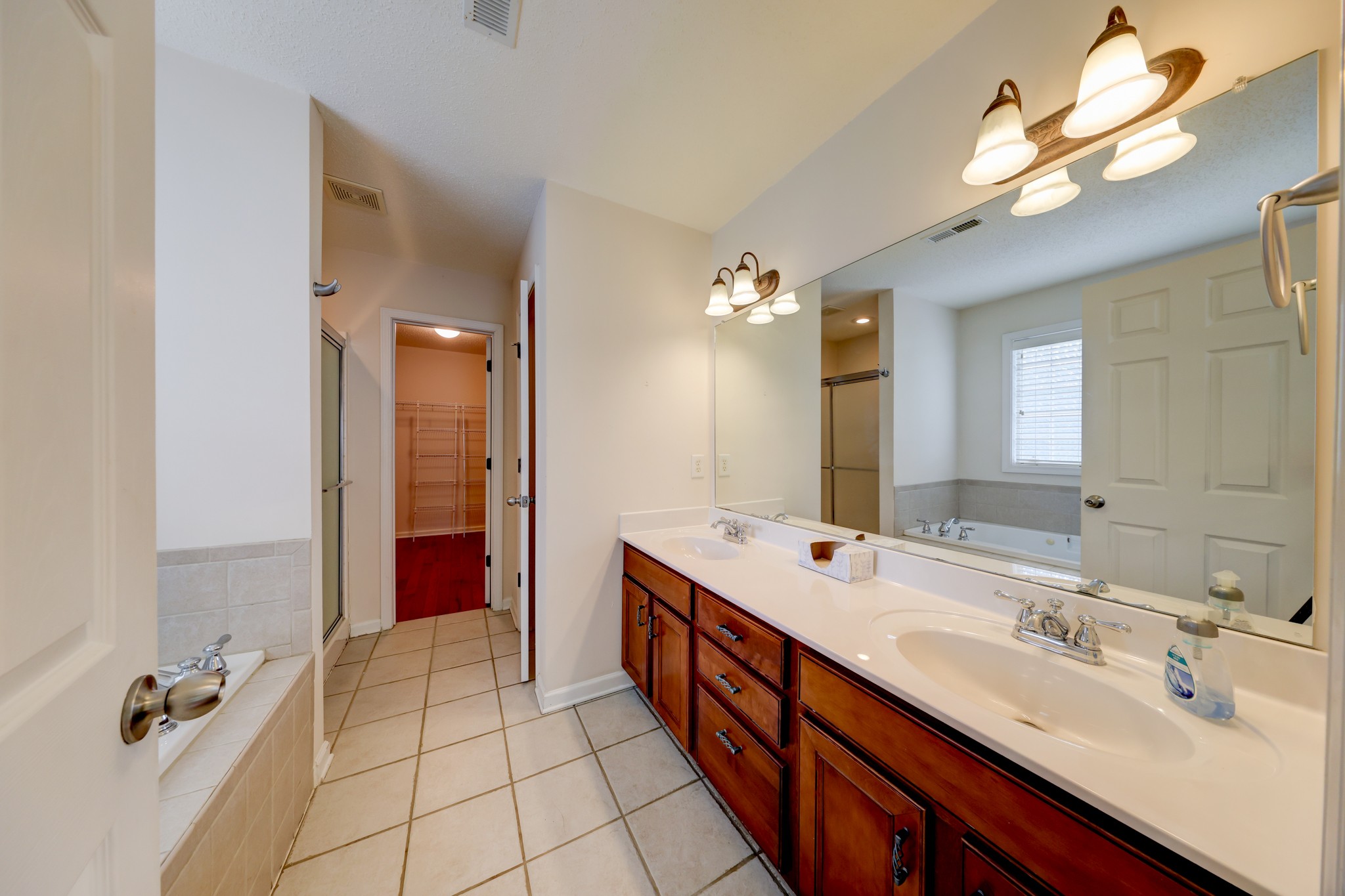 4445 Taylor Hall Lane Adams, TN 37010 - Photo 30 of 65 a spacious bathroom with a double vanity sink a mirror and a shower