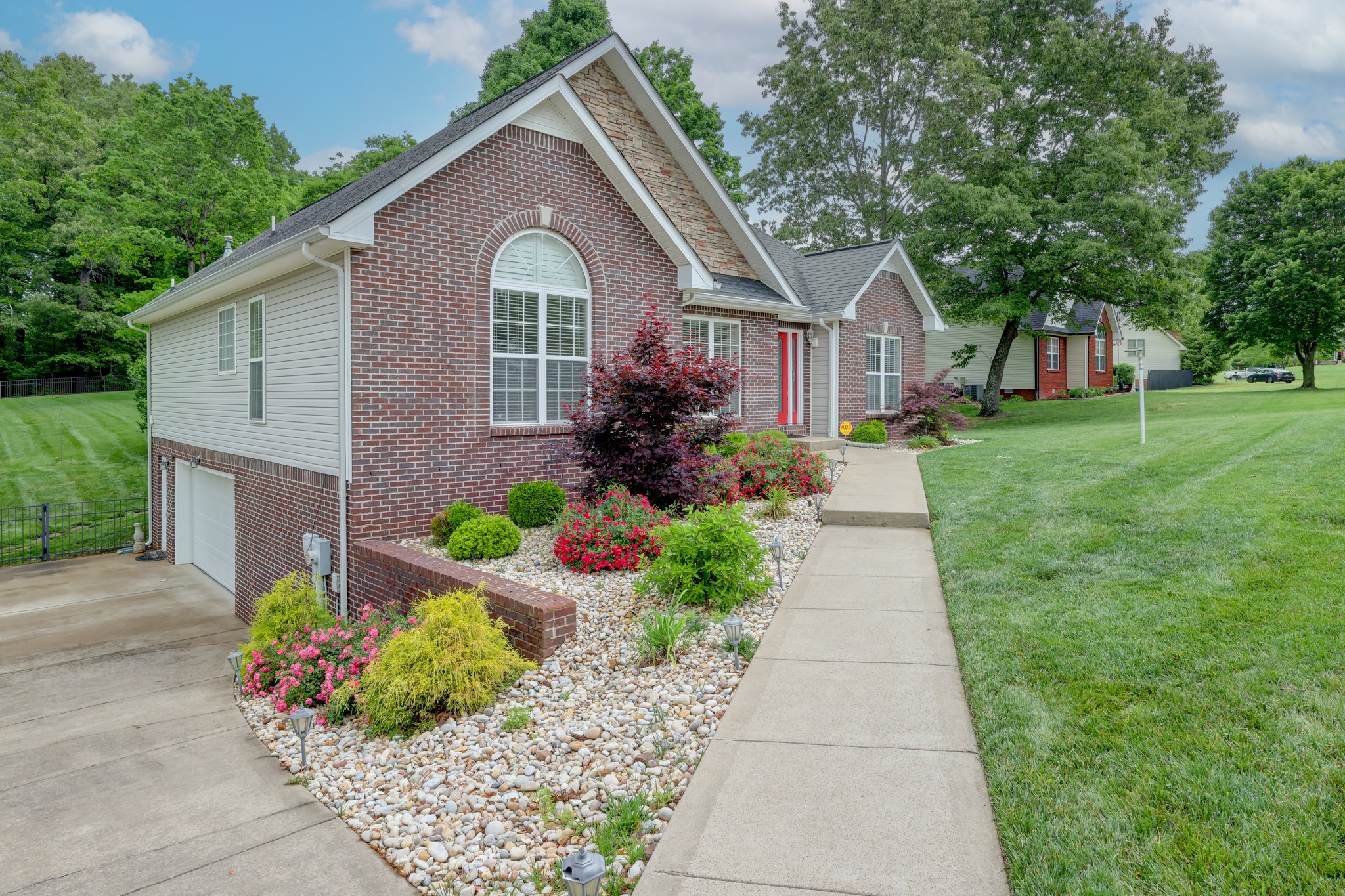 4445 Taylor Hall Lane Adams, TN 37010 - Photo 3 of 65 a front view of a house with a garden