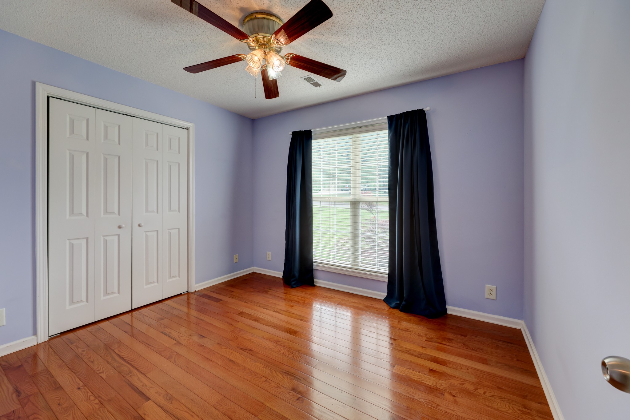 4445 Taylor Hall Lane Adams, TN 37010 - Photo 40 of 65 an empty room with wooden floor and windows