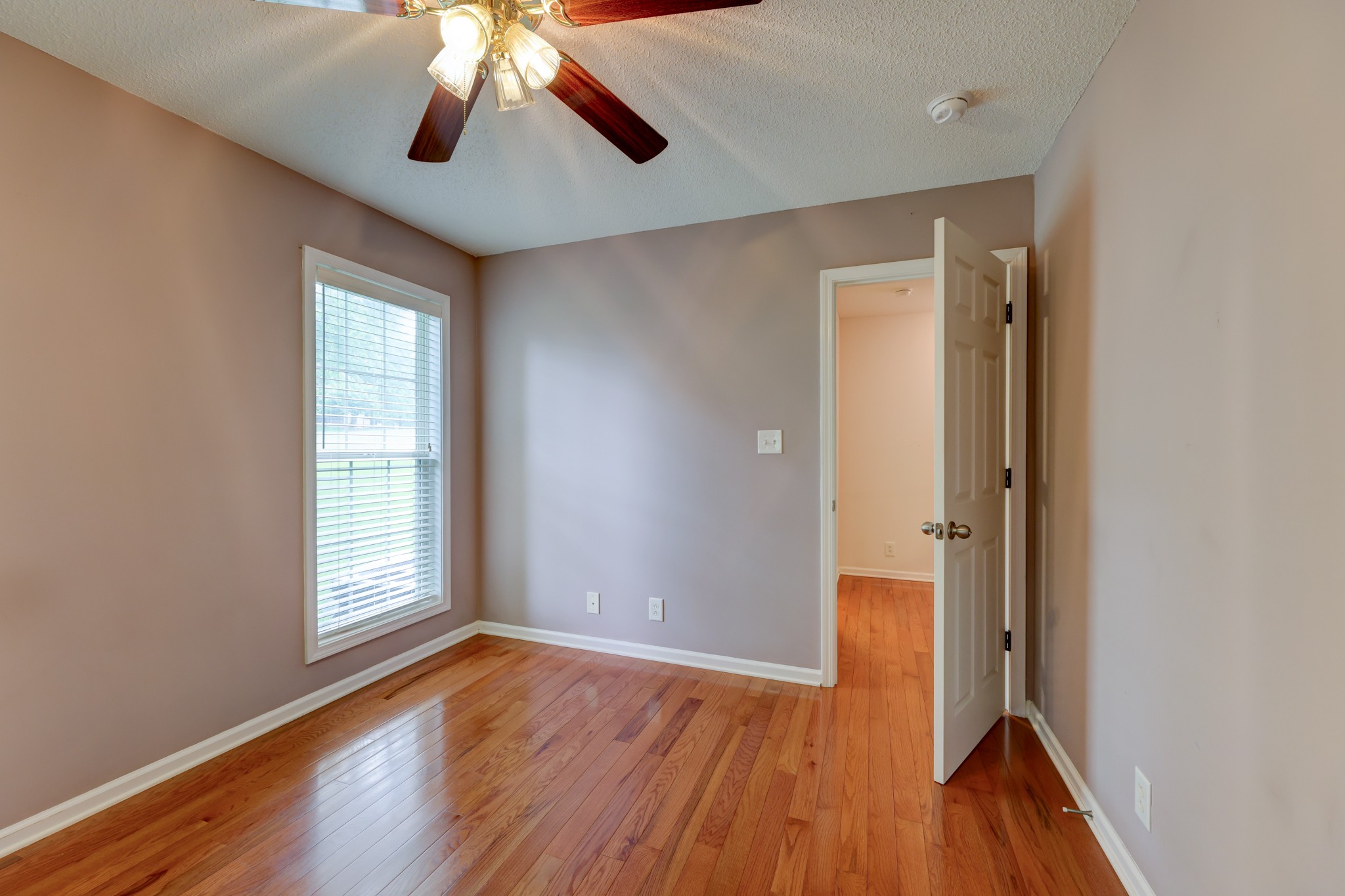 4445 Taylor Hall Lane Adams, TN 37010 - Photo 47 of 65 an empty room with wooden floor and windows