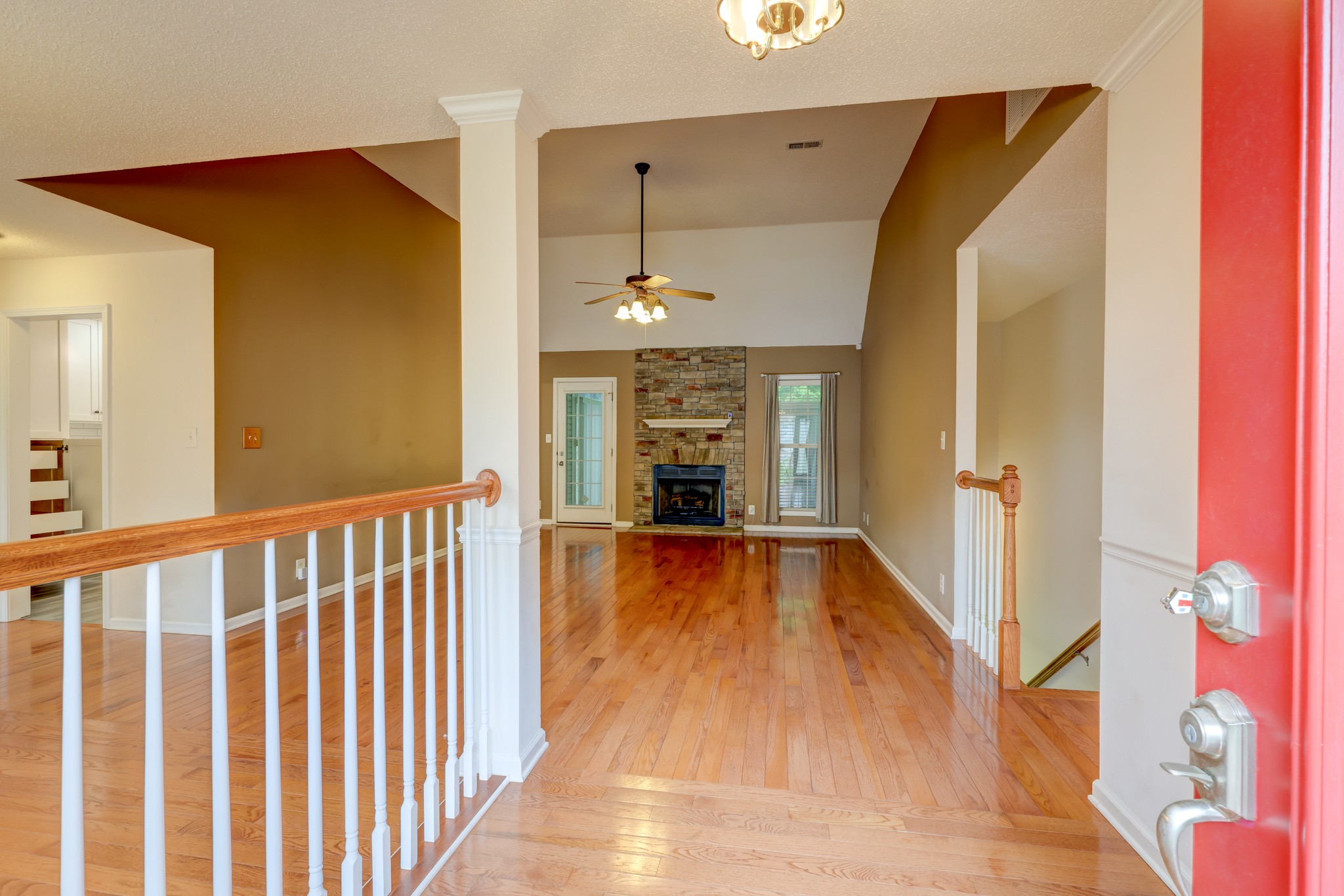4445 Taylor Hall Lane Adams, TN 37010 - Photo 5 of 65 a view of a hallway with wooden floor and staircase