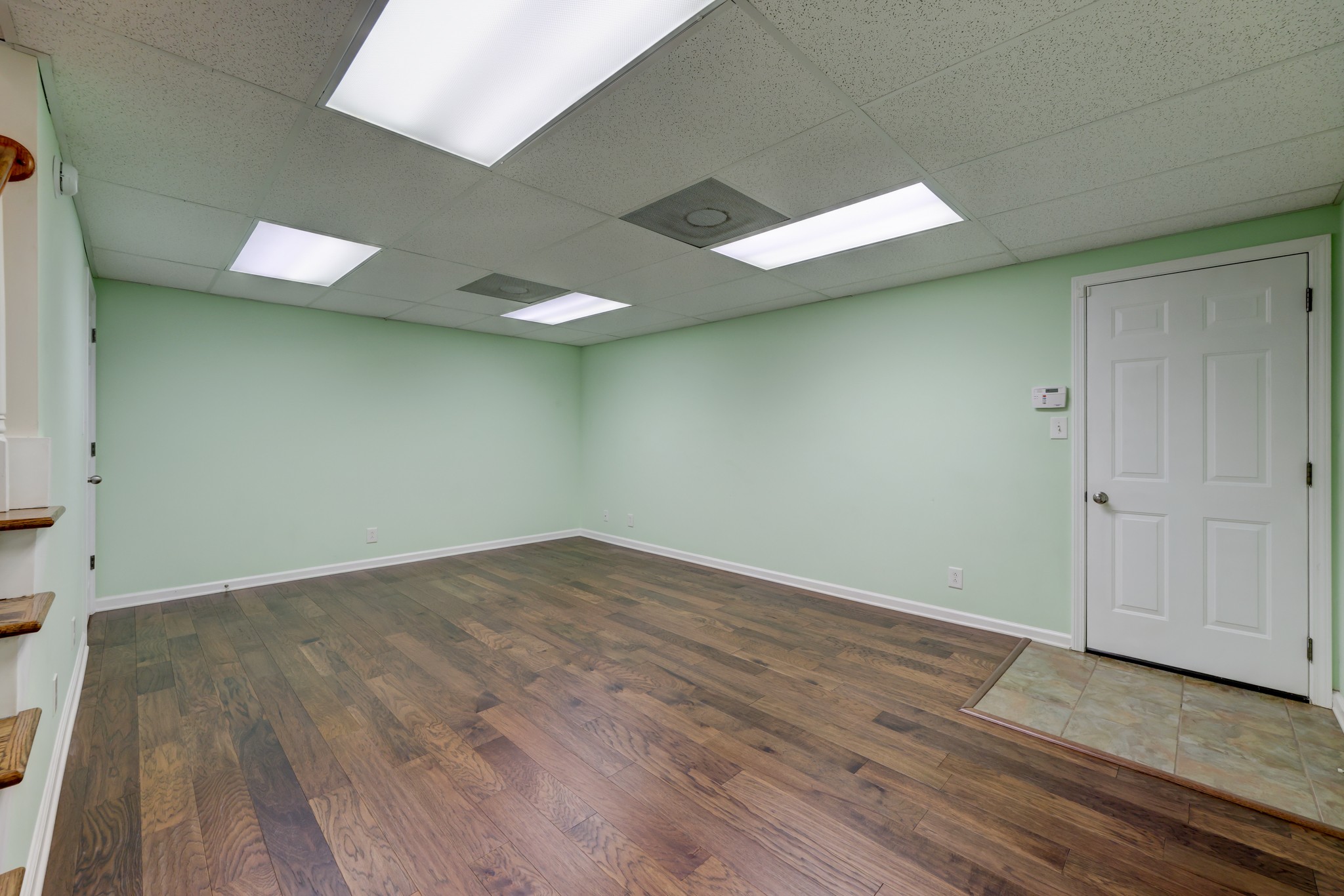 4445 Taylor Hall Lane Adams, TN 37010 - Photo 55 of 65 an empty room with wooden floor and windows