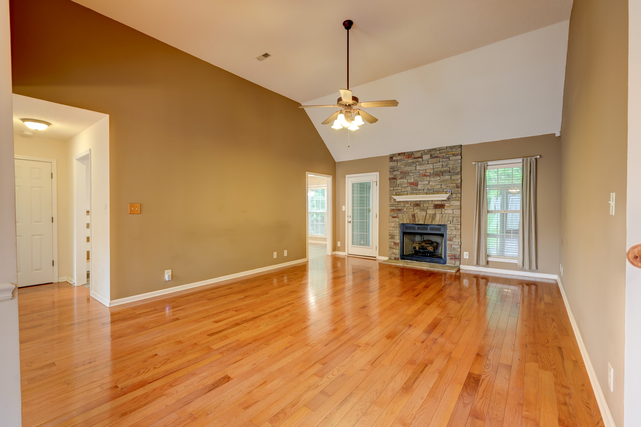 4445 Taylor Hall Lane Adams, TN 37010 - Photo 6 of 65 a view of a livingroom with a fireplace wooden floor and chandelier