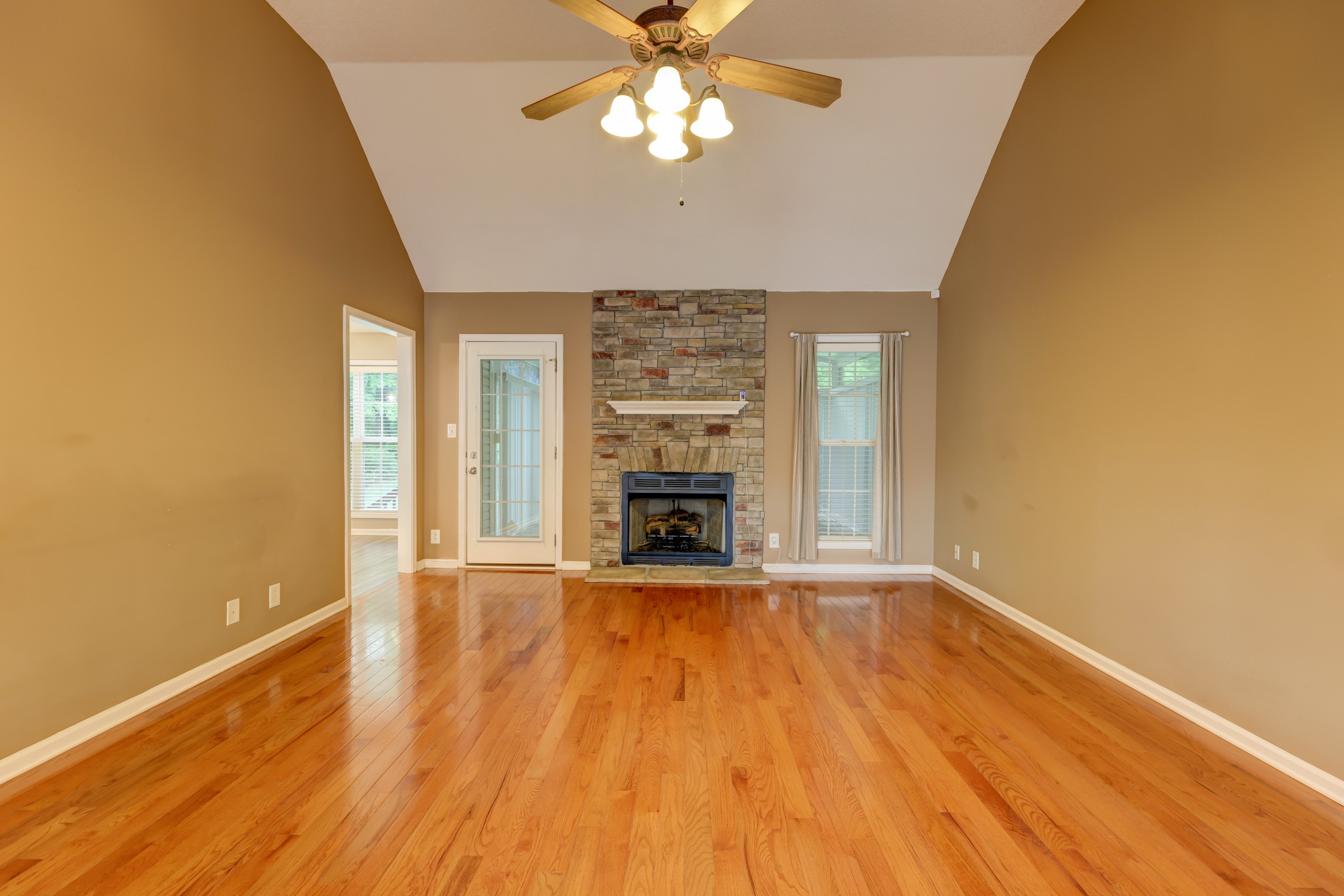 4445 Taylor Hall Lane Adams, TN 37010 - Photo 7 of 65 a view of an empty room with a fireplace and a window