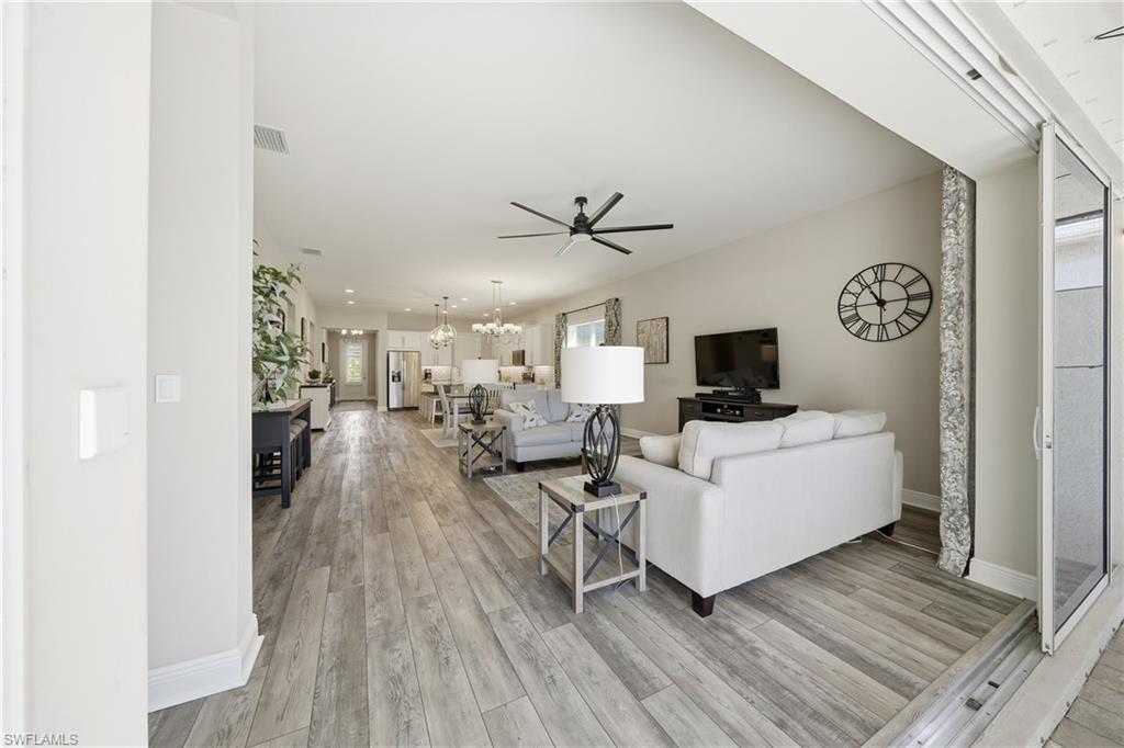 3344 Pilot Circle Naples, FL 34120 - Photo 12 of 50 a living room with furniture and a wooden floor