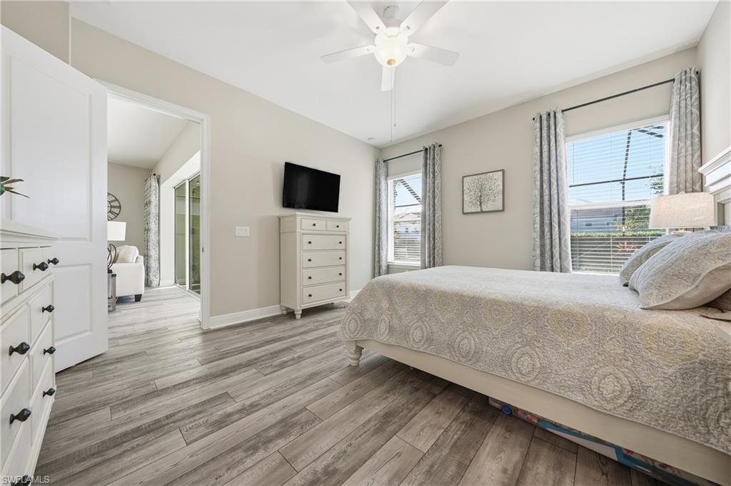 3344 Pilot Circle Naples, FL 34120 - Photo 17 of 50 a bedroom with a bed and a flat tv screen