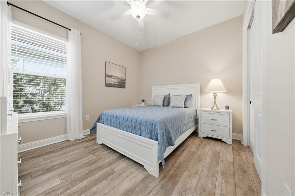 3344 Pilot Circle Naples, FL 34120 - Photo 20 of 50 a bedroom with a large bed and a chandelier