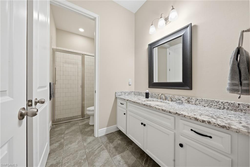 3344 Pilot Circle Naples, FL 34120 - Photo 22 of 50 a bathroom with a granite countertop sink vanity mirror and a