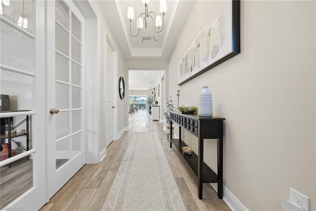 3344 Pilot Circle Naples, FL 34120 - Photo 23 of 50 a view of a hallway with wooden floor and staircase