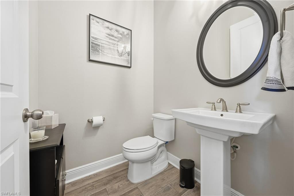 3344 Pilot Circle Naples, FL 34120 - Photo 27 of 50 a bathroom with a toilet sink and mirror