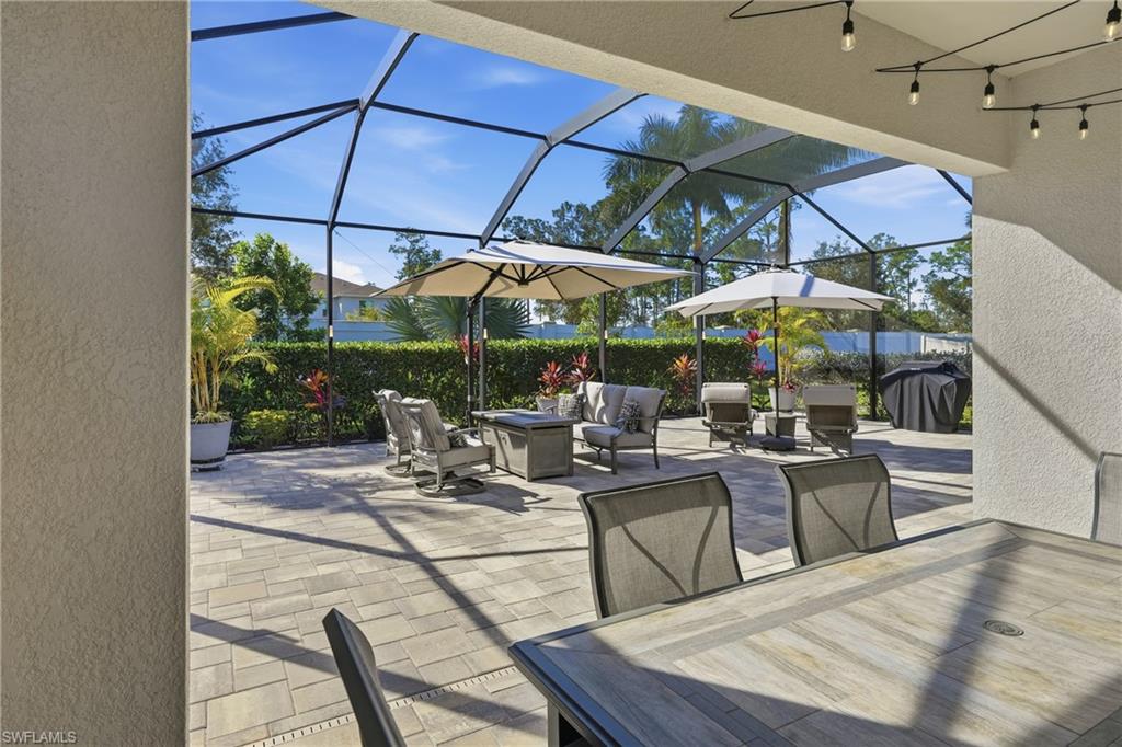 3344 Pilot Circle Naples, FL 34120 - Photo 31 of 50 a view of a patio with chairs and an umbrella