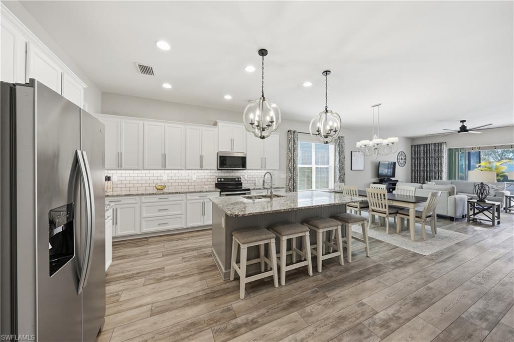 3344 Pilot Circle Naples, FL 34120 - Photo 50 of 50 a large kitchen with a table and chairs