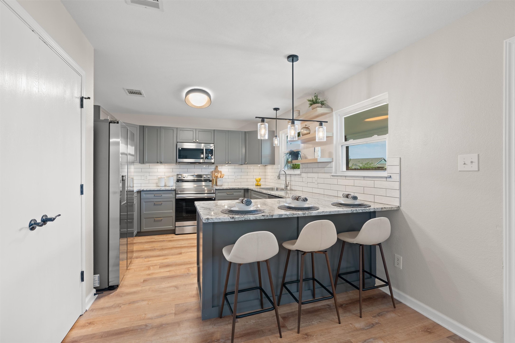 724 Lavaca Loop Elgin, TX 78621 - Photo 9 of 40 Gleaming stone countertops and modern cabinetry highlight this highly functional, open kitchen design.