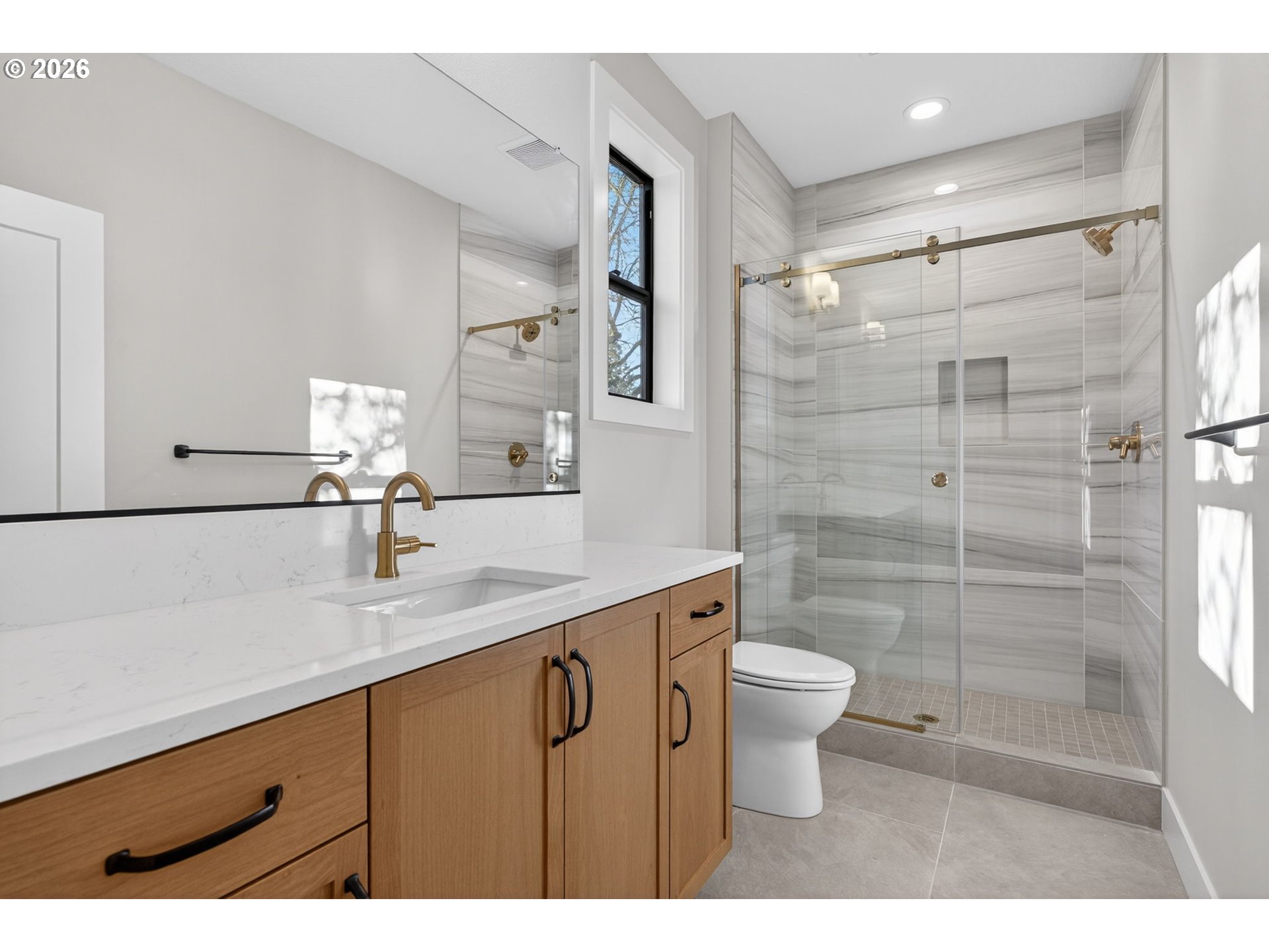 7705 Southwest Alden Street Portland, OR 97223 - Photo 14 of 30 a bathroom with a sink a toilet and shower