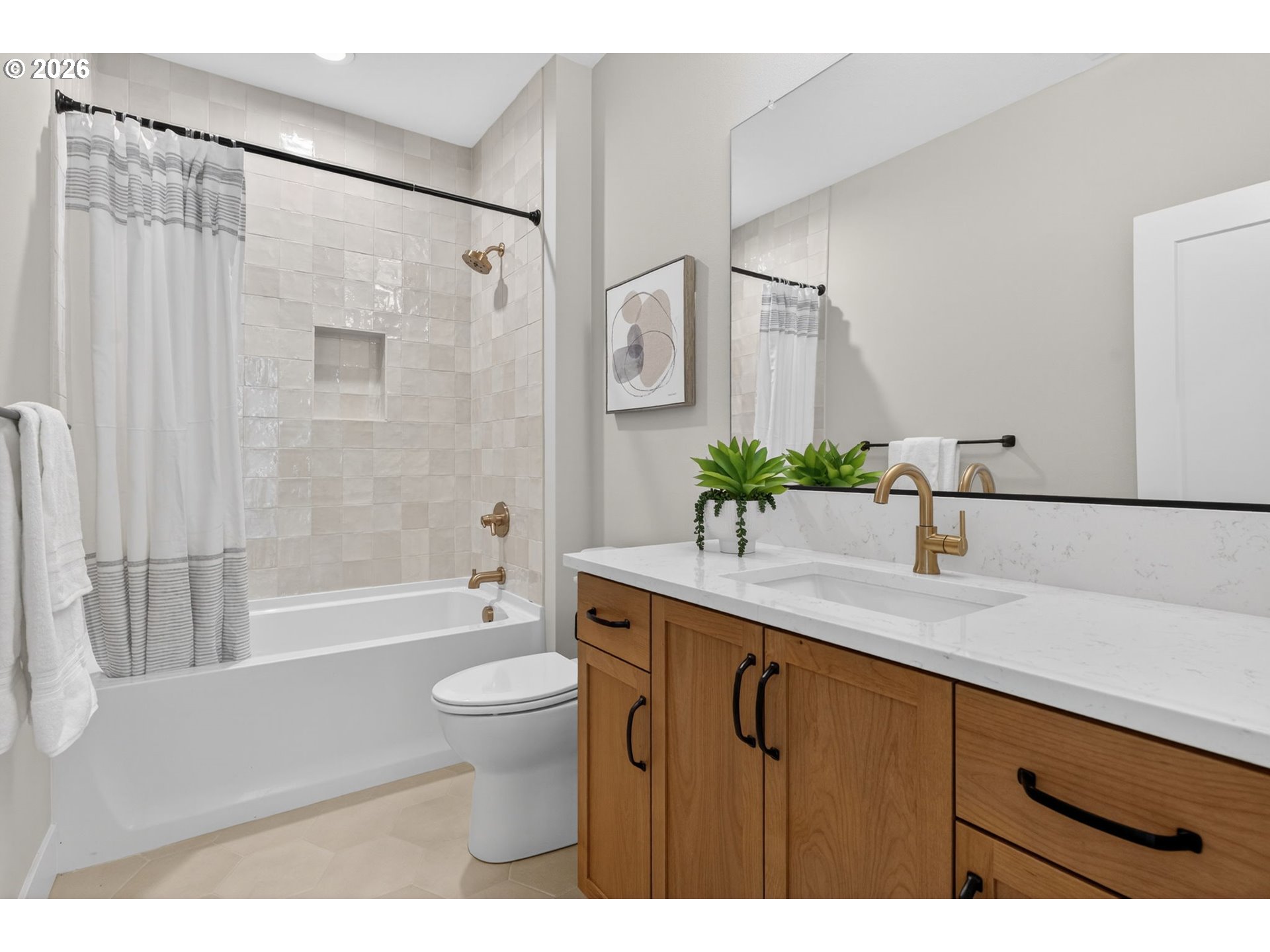 7705 Southwest Alden Street Portland, OR 97223 - Photo 18 of 30 a bathroom with a granite countertop sink a toilet a large mirror a bathtub and shower