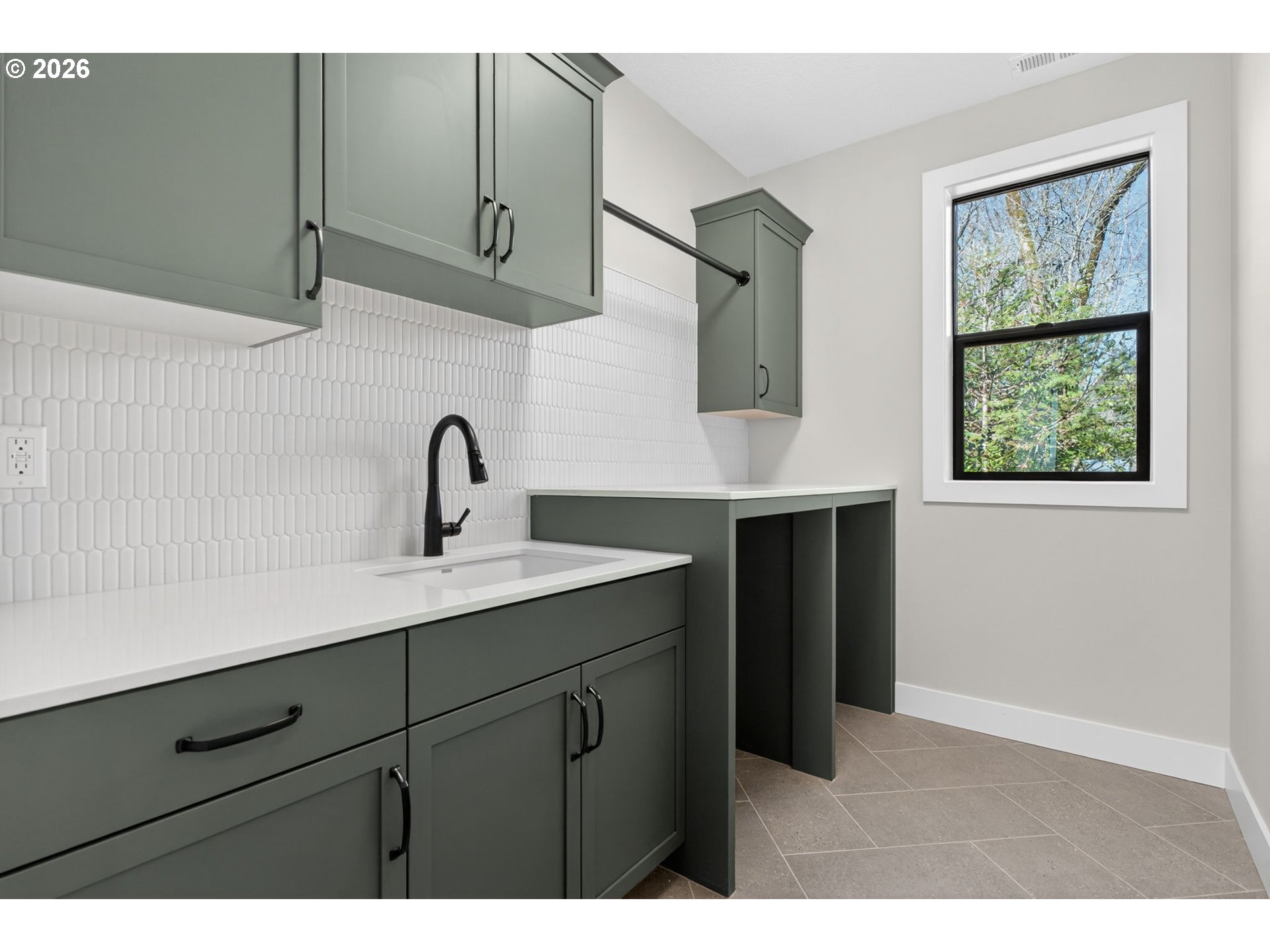 7705 Southwest Alden Street Portland, OR 97223 - Photo 19 of 30 a kitchen with a sink cabinets and a window