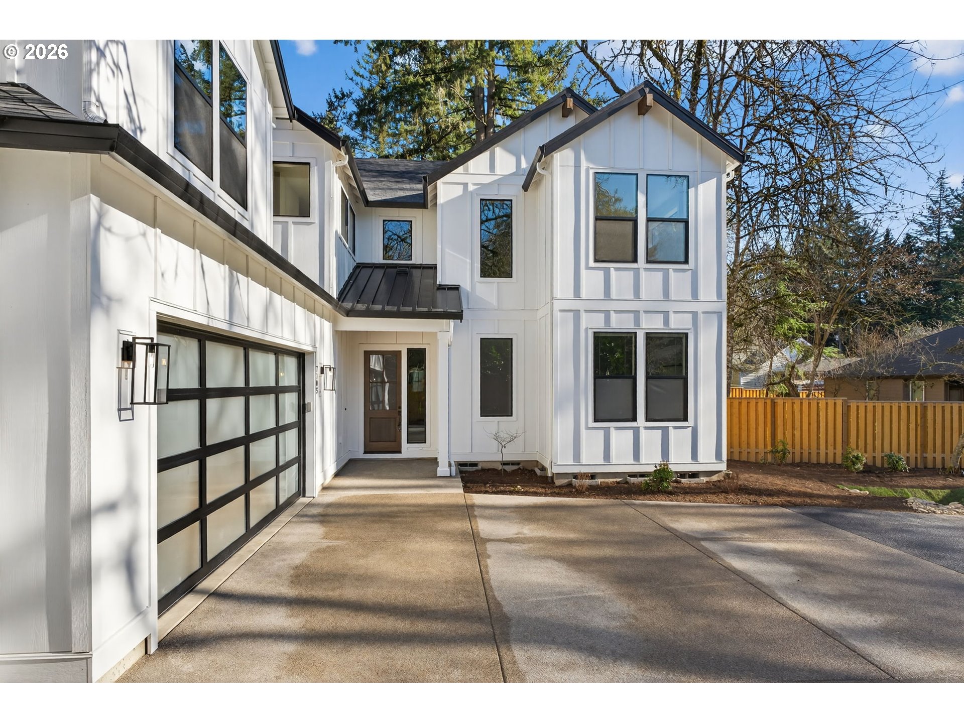 7705 Southwest Alden Street Portland, OR 97223 - Photo 27 of 30 a front view of a house with a lots of windows and tree