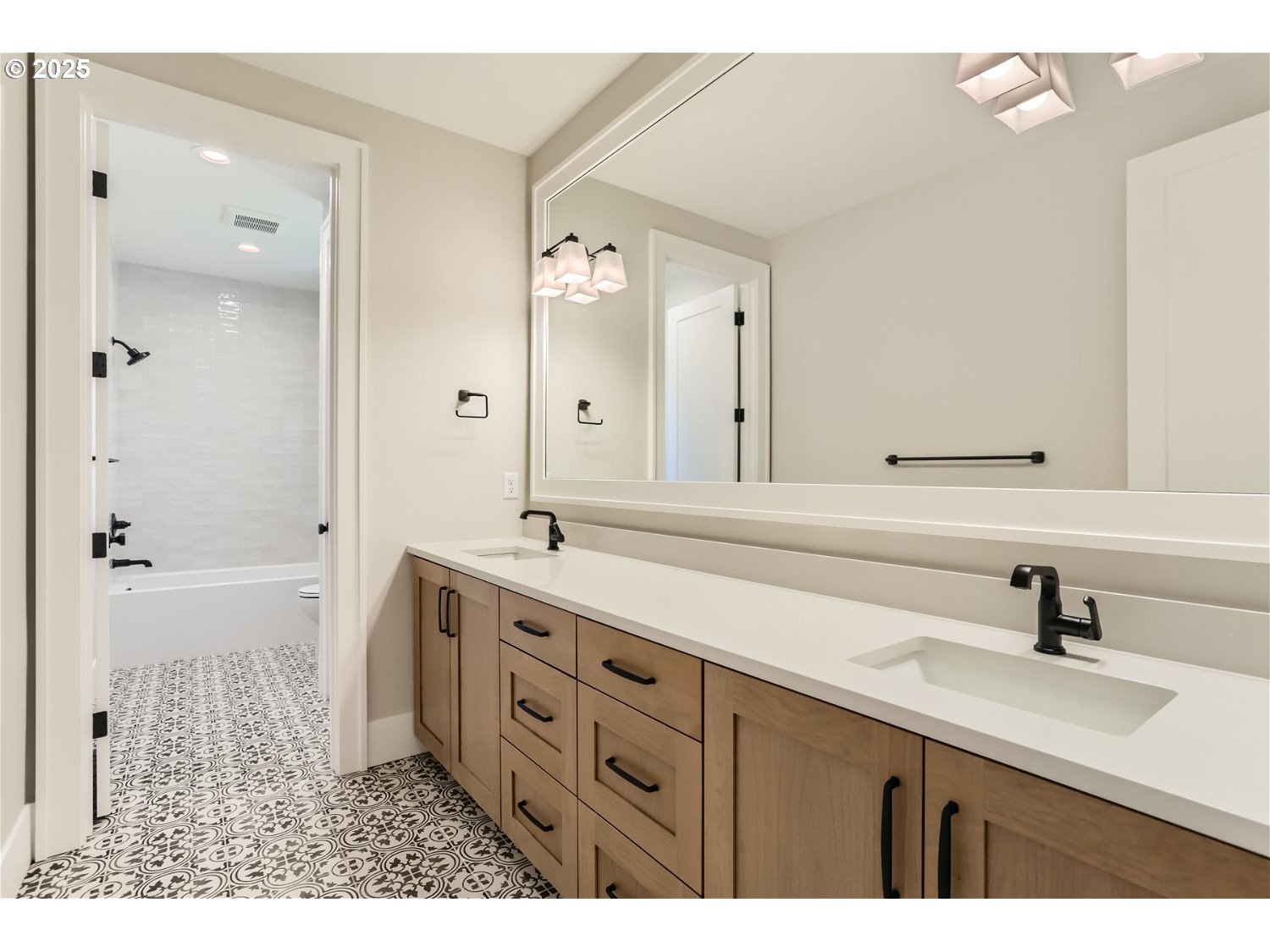 7705 Southwest Alden Street Portland, OR 97223 - Photo 9 of 30 a bathroom with a double vanity sink mirror and shower