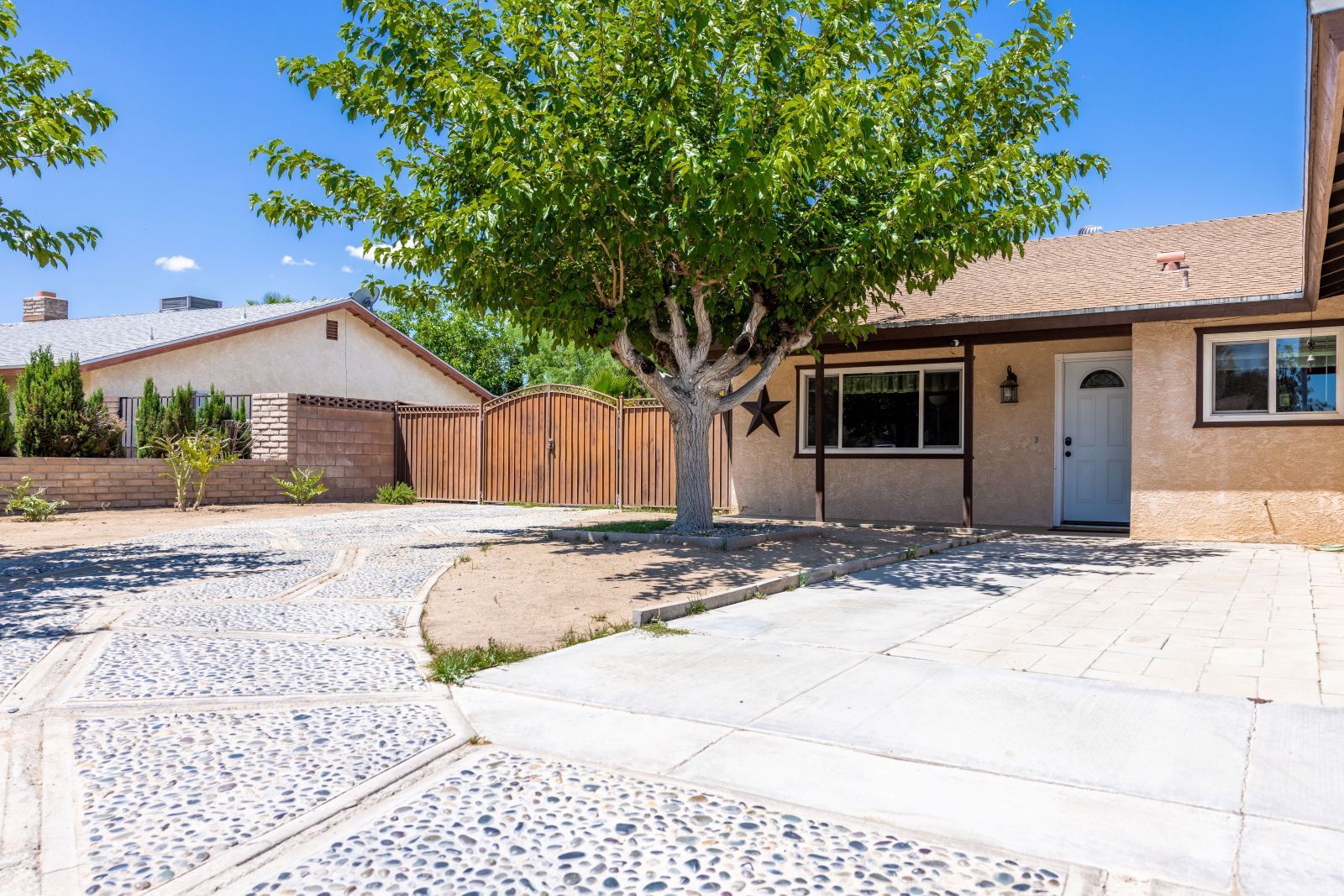 313 Larkspur Street Ridgecrest, CA 93555 - Photo 3 of 31 a front view of a house with a yard and garage