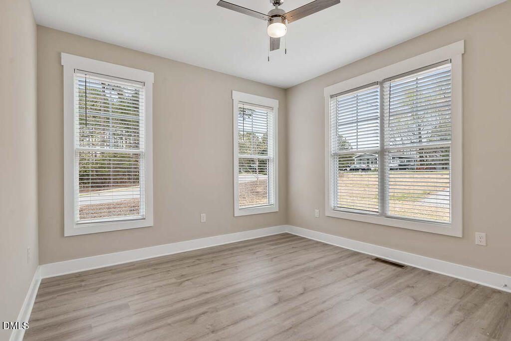 2305 Hill Street Raleigh, NC 27604 - Photo 11 of 26 a view of an empty room with wooden floor and a window