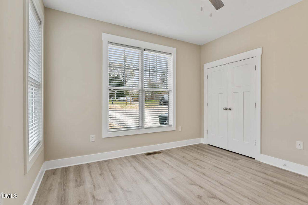 2305 Hill Street Raleigh, NC 27604 - Photo 12 of 26 a view of an empty room with wooden floor and a window