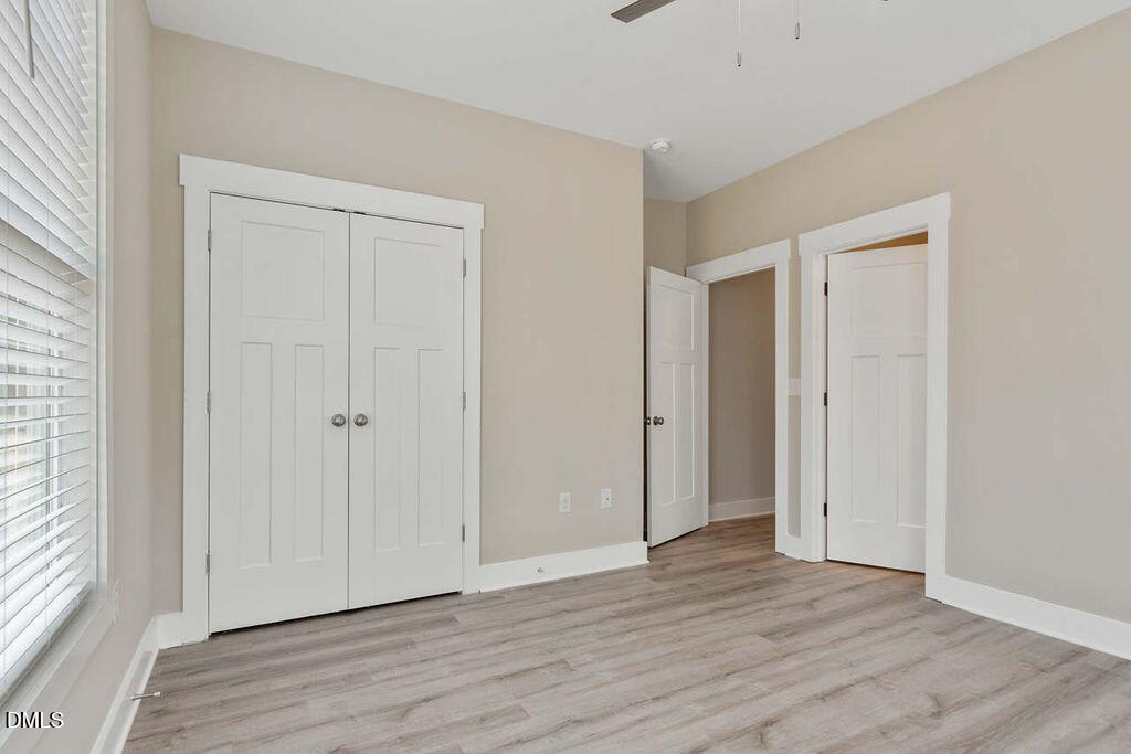 2305 Hill Street Raleigh, NC 27604 - Photo 13 of 26 a view of an empty room with wooden floor and a window