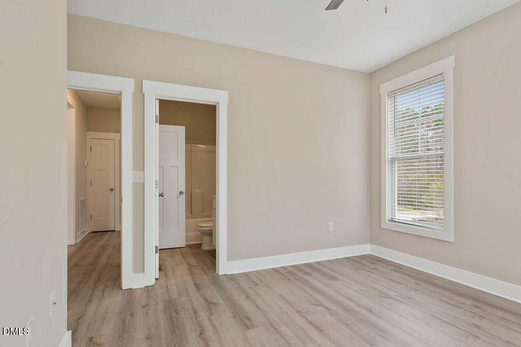2305 Hill Street Raleigh, NC 27604 - Photo 14 of 26 an empty room with wooden floor and a window