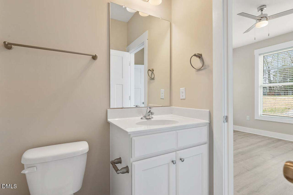 2305 Hill Street Raleigh, NC 27604 - Photo 16 of 26 a bathroom with a toilet sink and mirror