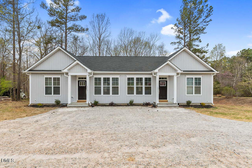 2305 Hill Street Raleigh, NC 27604 - Photo 2 of 26 a front view of a house with a garden and trees