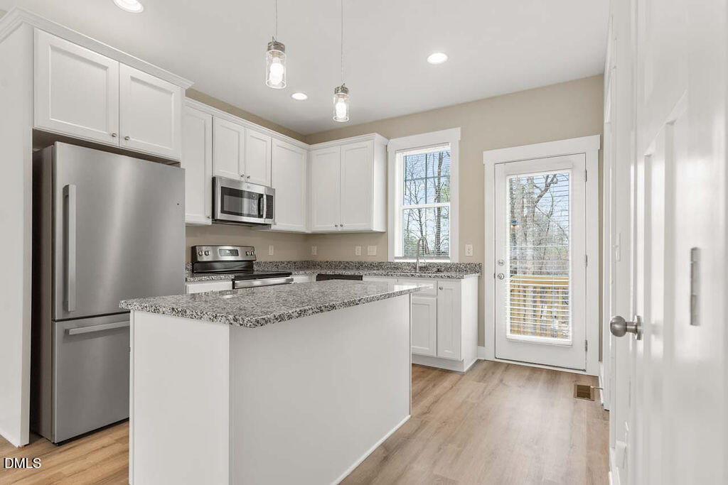 2305 Hill Street Raleigh, NC 27604 - Photo 22 of 26 a kitchen with a refrigerator a sink and cabinets