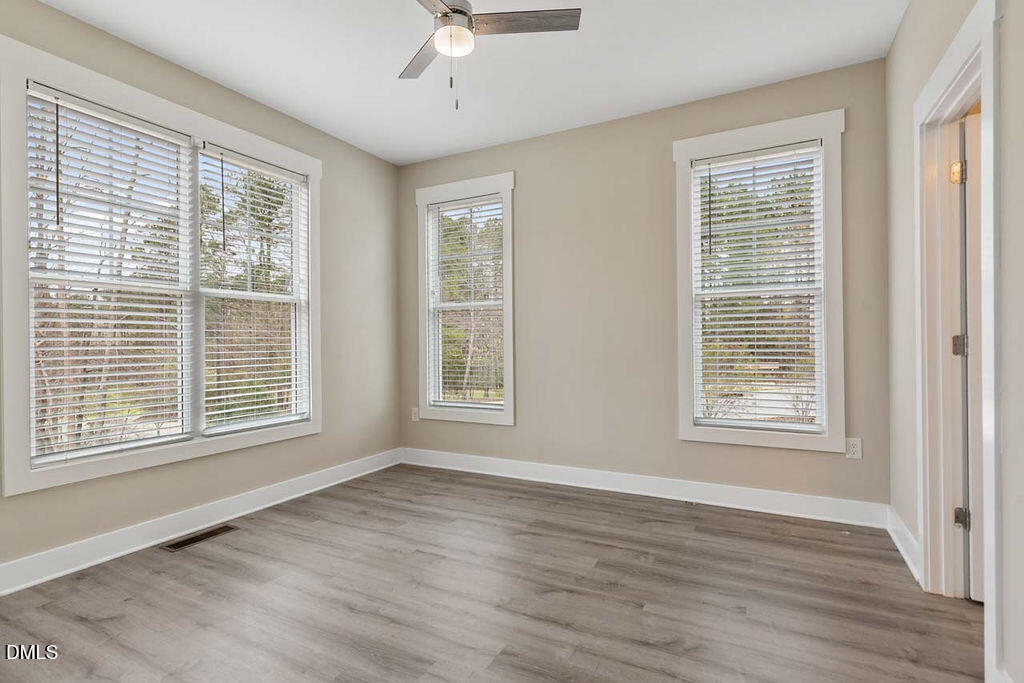2305 Hill Street Raleigh, NC 27604 - Photo 7 of 26 a view of an empty room with wooden floor and a window