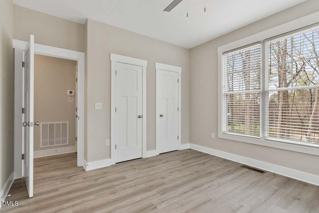 2305 Hill Street Raleigh, NC 27604 - Photo 8 of 26 a view of an empty room with wooden floor and a window