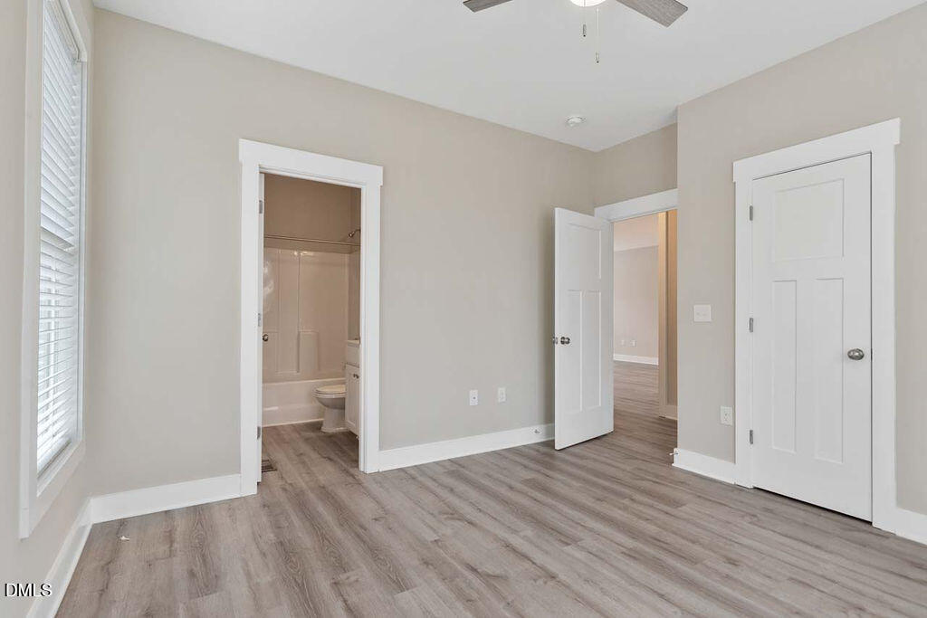 2305 Hill Street Raleigh, NC 27604 - Photo 9 of 26 an empty room with wooden floor and windows