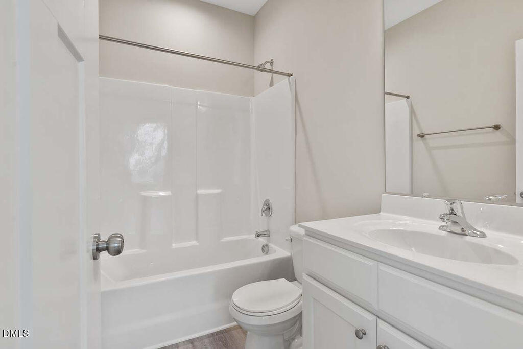 2305 Hill Street Raleigh, NC 27604 - Photo 10 of 26 a bathroom with a sink a toilet and a bathtub