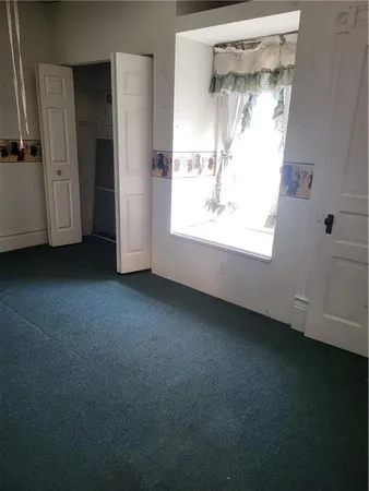 a view of empty room with closet