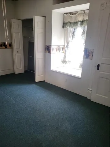a view of empty room with closet