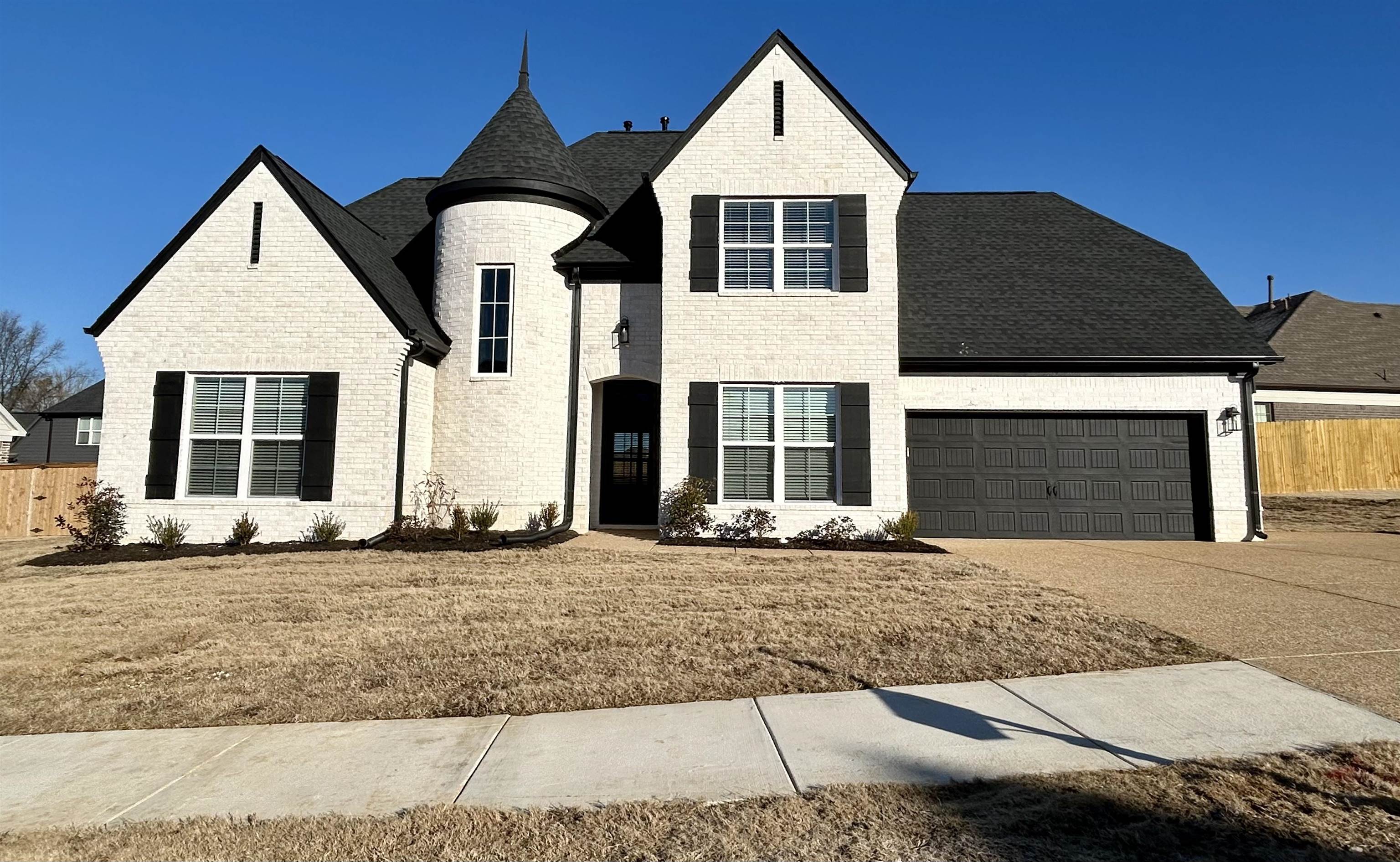 7819 Shadowcrest Road Memphis, TN 38125 - Photo 1 of 4 View of front of house with a front yard and a garage