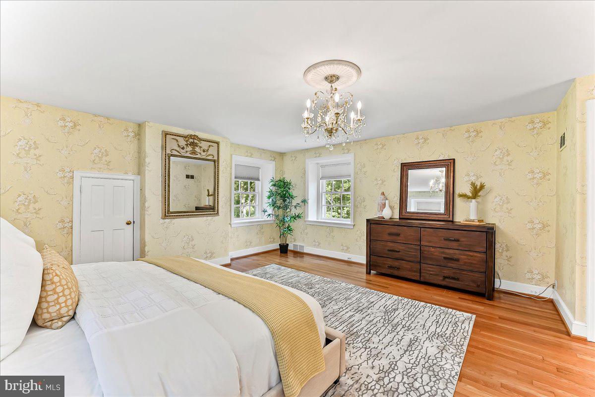 716 Old Gulph Road Bryn Mawr, PA 19010 - Photo 26 of 58 a bedroom with a bed and wooden floor