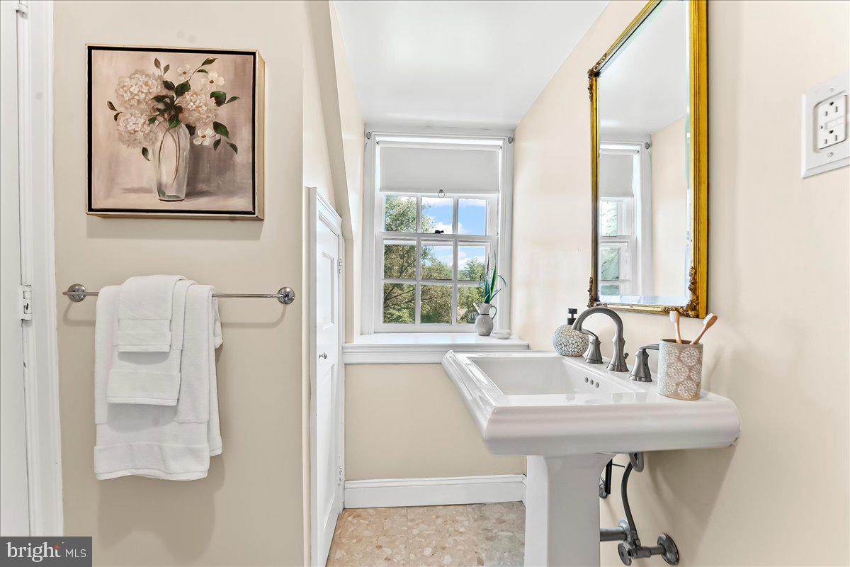 716 Old Gulph Road Bryn Mawr, PA 19010 - Photo 37 of 58 a bathroom with a sink and a mirror