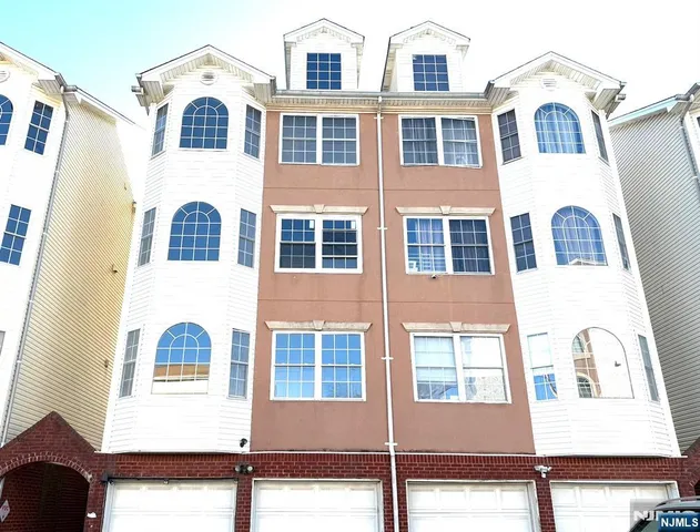 a front view of a residential apartment building with a yard