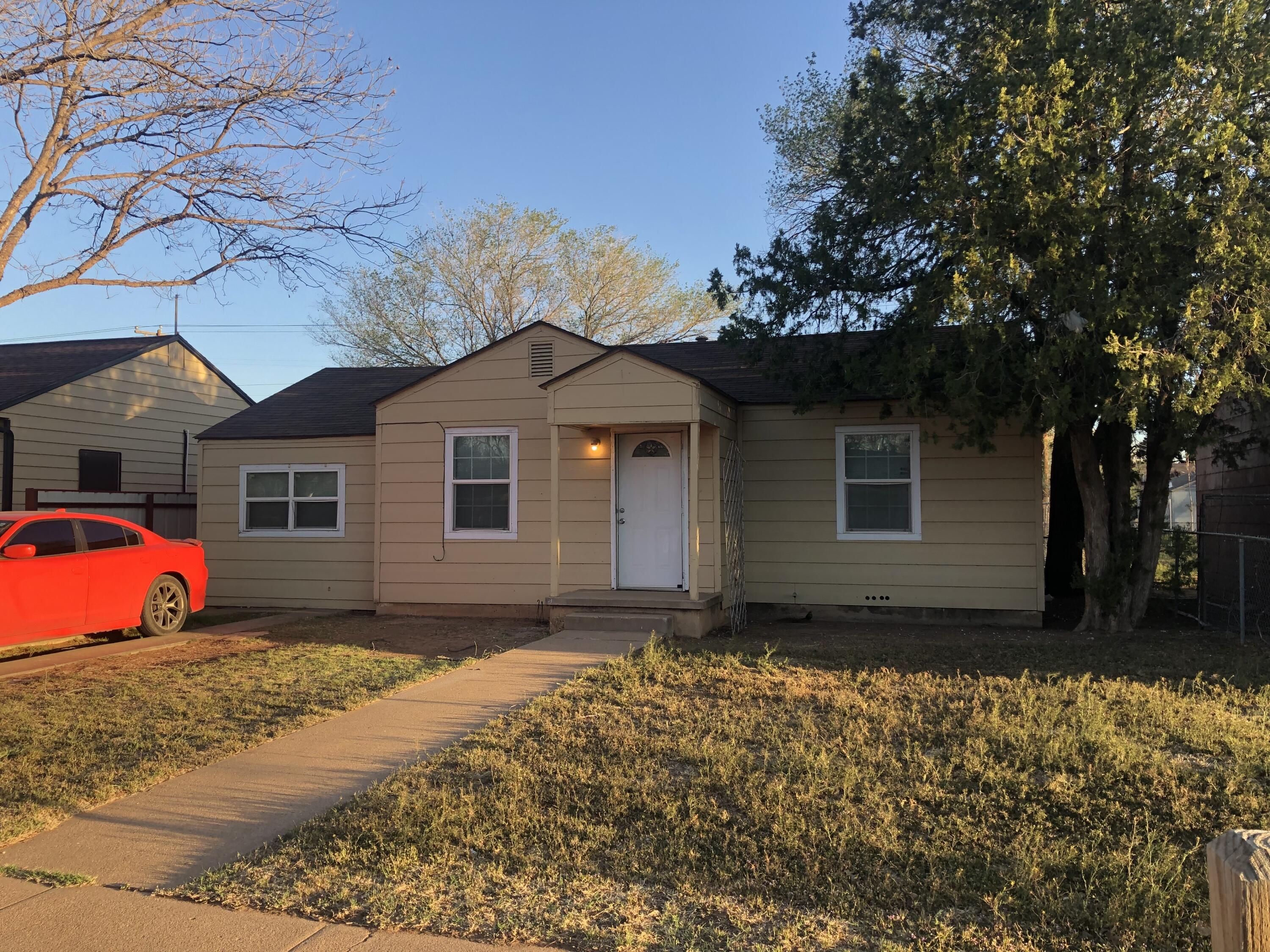 5107 40th Street Lubbock, TX 79414 - Photo 3 of 10 a front view of a house with a yard