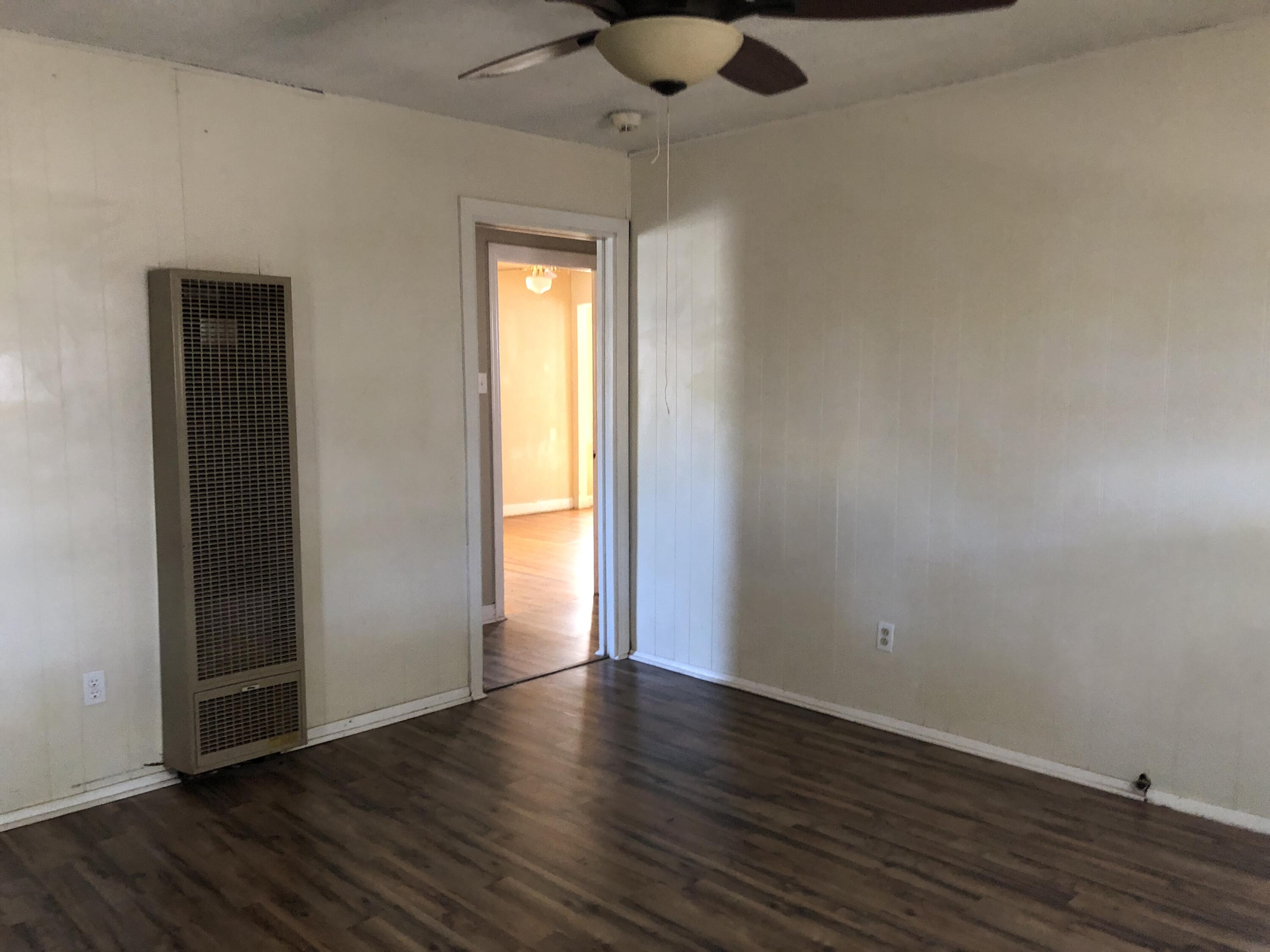 5107 40th Street Lubbock, TX 79414 - Photo 7 of 10 an empty room with wooden floor and windows